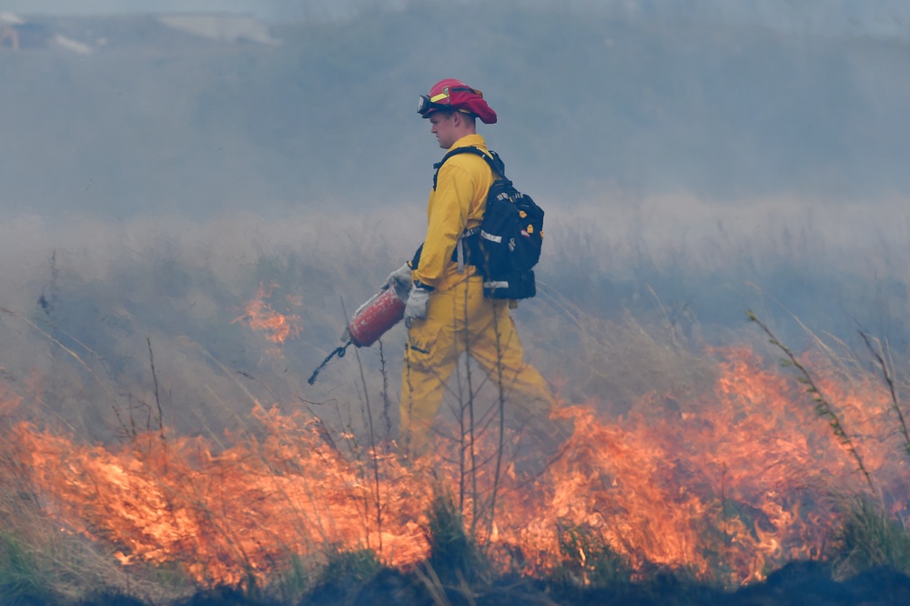 Firefighting personnel conduct controlled burns on JBER