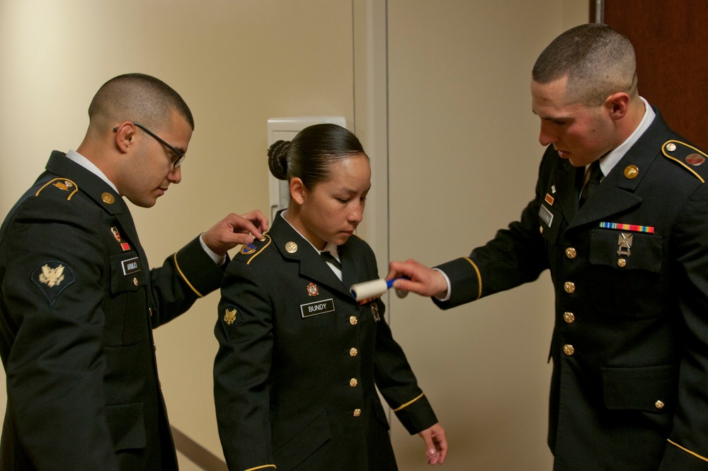 Soldiers review each others uniform prior to appearance board