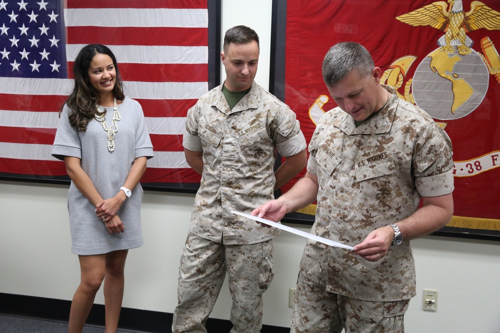 Marine awarded plaque and check for winning Lt. Col. Earl “Pere” Hancock Ellis Essay Contest
