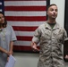 Marine awarded plaque and check for winning Lt. Col. Earl “Pere” Hancock Ellis Essay Contest