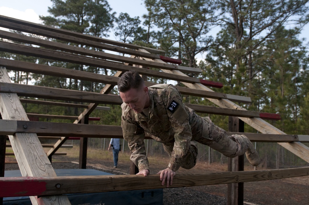 Staff Sgt. Joseph Young tackles the Weaver Obstacle during Best Warrior Competition