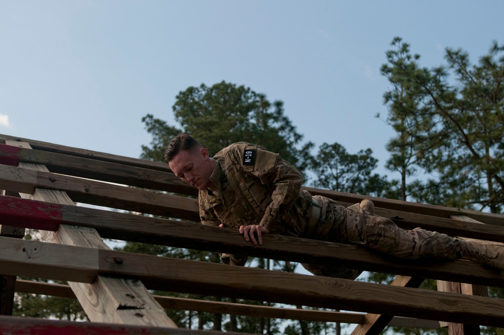Soldier navigates the Weaver at the Air Assault Obstacle Course