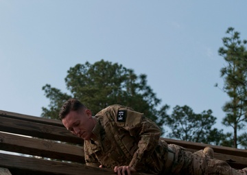Soldier navigates the Weaver at the Air Assault Obstacle Course