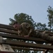 Soldier navigates the Weaver at the Air Assault Obstacle Course