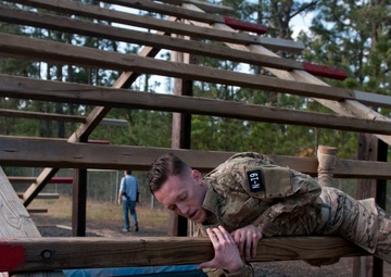 Musician tackles obstacle during Air Assault Obstacle Course