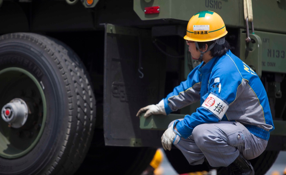 A Japanese embarkation contractor ensures cargo is safely unloaded for Artillery Relocation Training Program 16-1