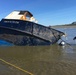 Salvage experts attempt to salvage beached fishing vessel