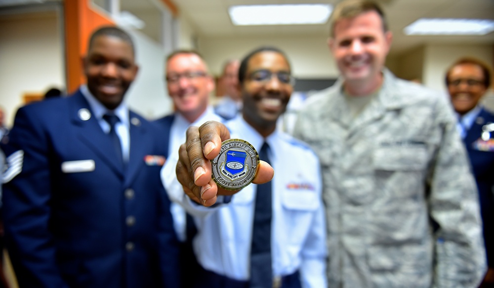 Airman presented a token of superior performance