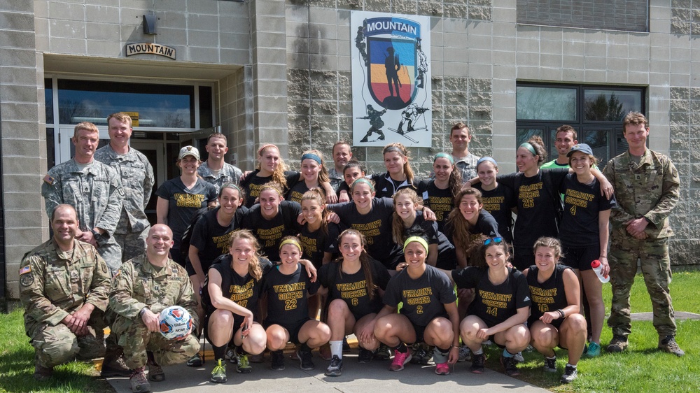 Army Mountain Warfare School Soldiers Pose with UVM Women's Soccer Team