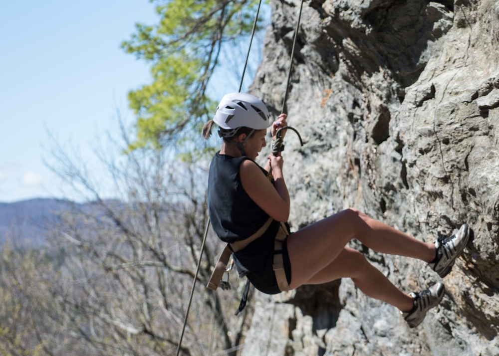 A Soccer Player Rappels Down a Rock Face