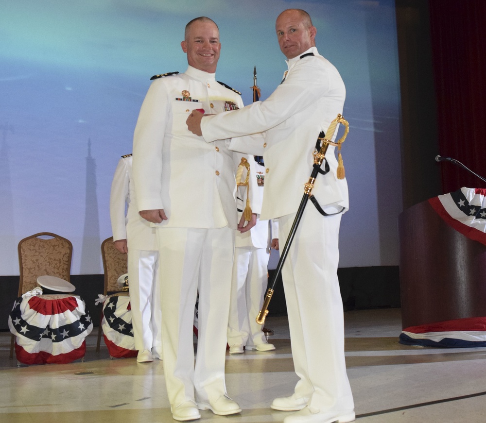 Capt. Jeffrey Grimes presents Cmdr. Lance Thompson the Legion of Merit
