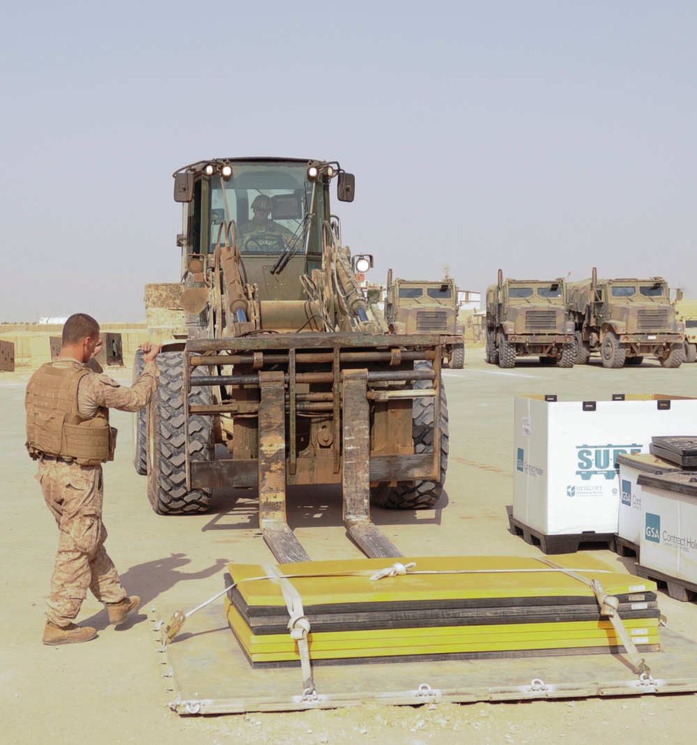 Soldier, Marine work together to move mats