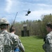 Soldiers Observe a Descending Black hawk