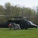 Crew Chief Directs Soldiers Exiting a Black Hawk