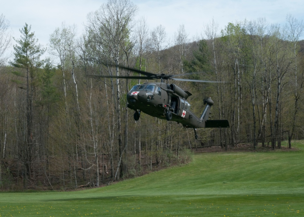 A U.S. Army HH-60M Black Hawk helicopter lands in a parade field at Camp Ethan Allen Training Site 