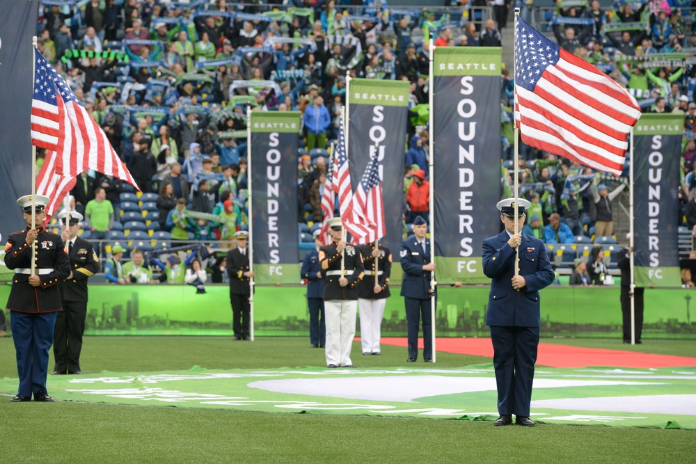 Members of the United States Coast Guard participate in half time