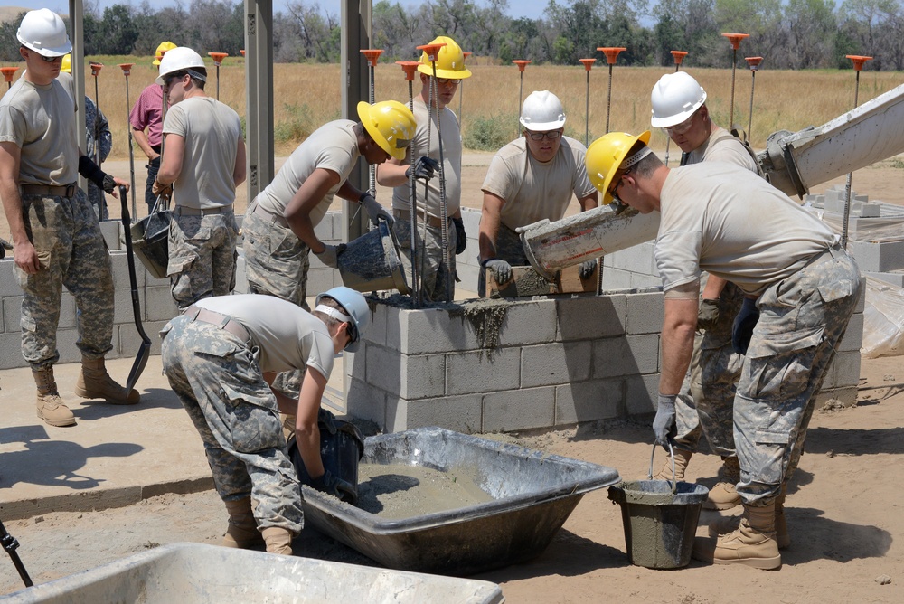 Soldiers work together to construct restroom