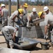 Soldiers work together to construct restroom