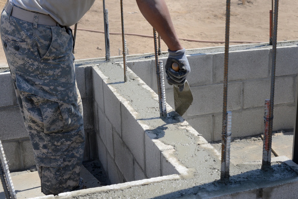 Soldier pours cement