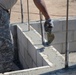 Soldier pours cement