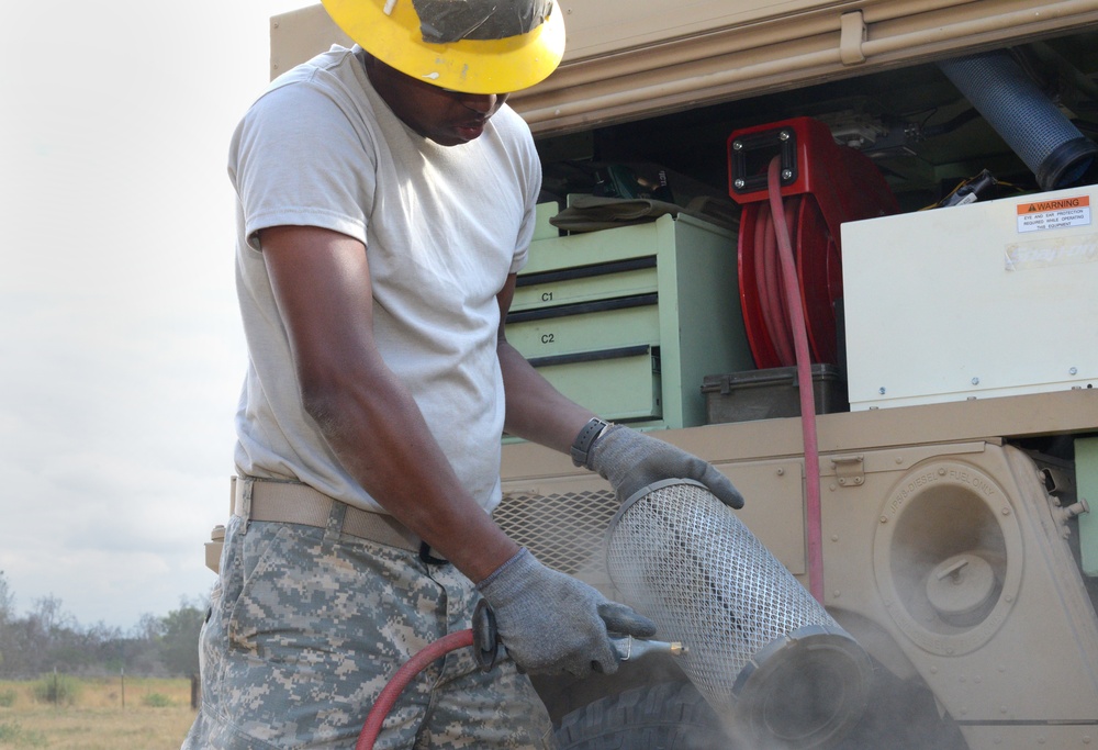 Soldier cleans out air filter