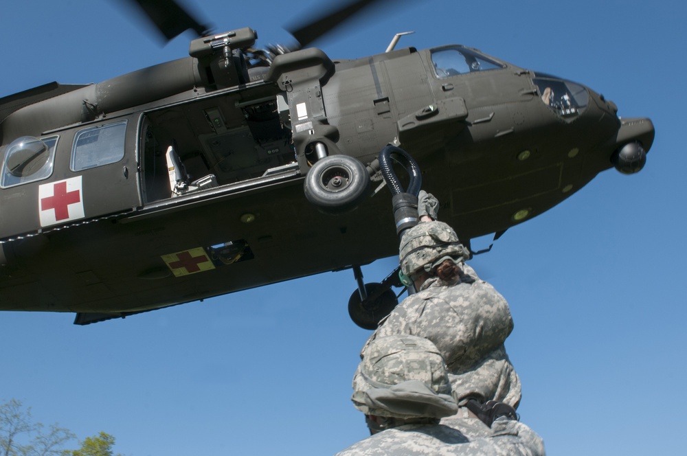 Soldiers Attach Sling Load to Black Hawk