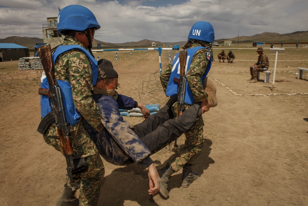 Service members with the Malaysian Army participate in riot control training during Khaan Quest 2016