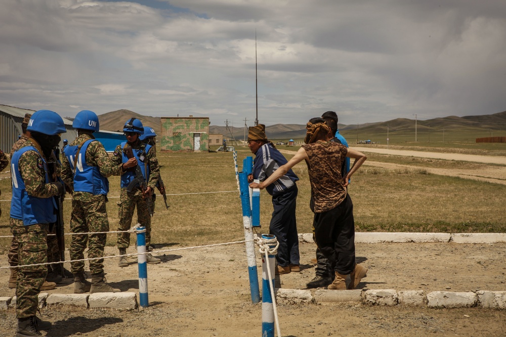 Service members with the Malaysian Army participate in riot control training during Khaan Quest 2016