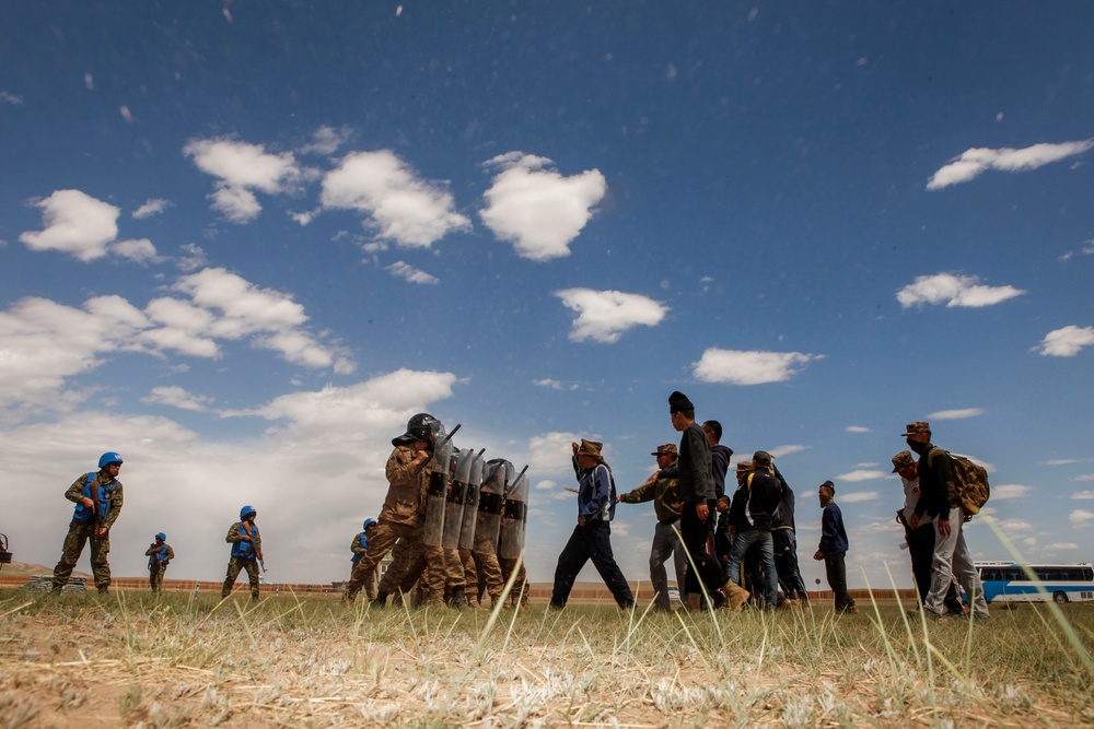 Service members with the Malaysian Army participate in riot control training during Khaan Quest 2016