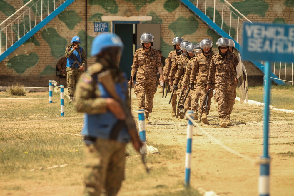 Service members with the Malaysian Army participate in riot control training during Khaan Quest 2016