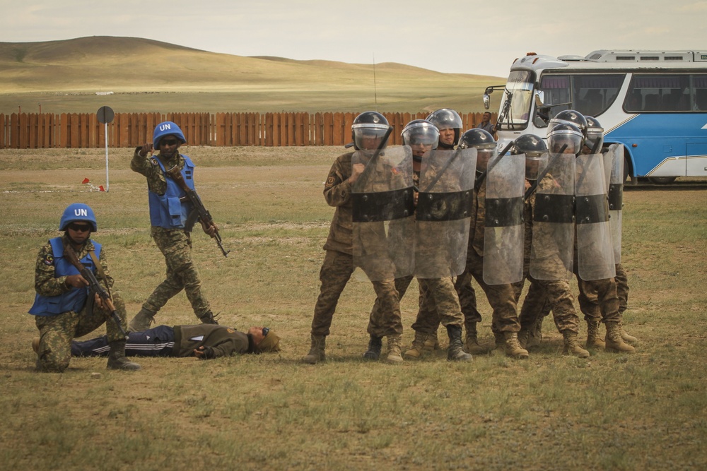 Service members with the Malaysian Army participate in riot control training during Khaan Quest 2016