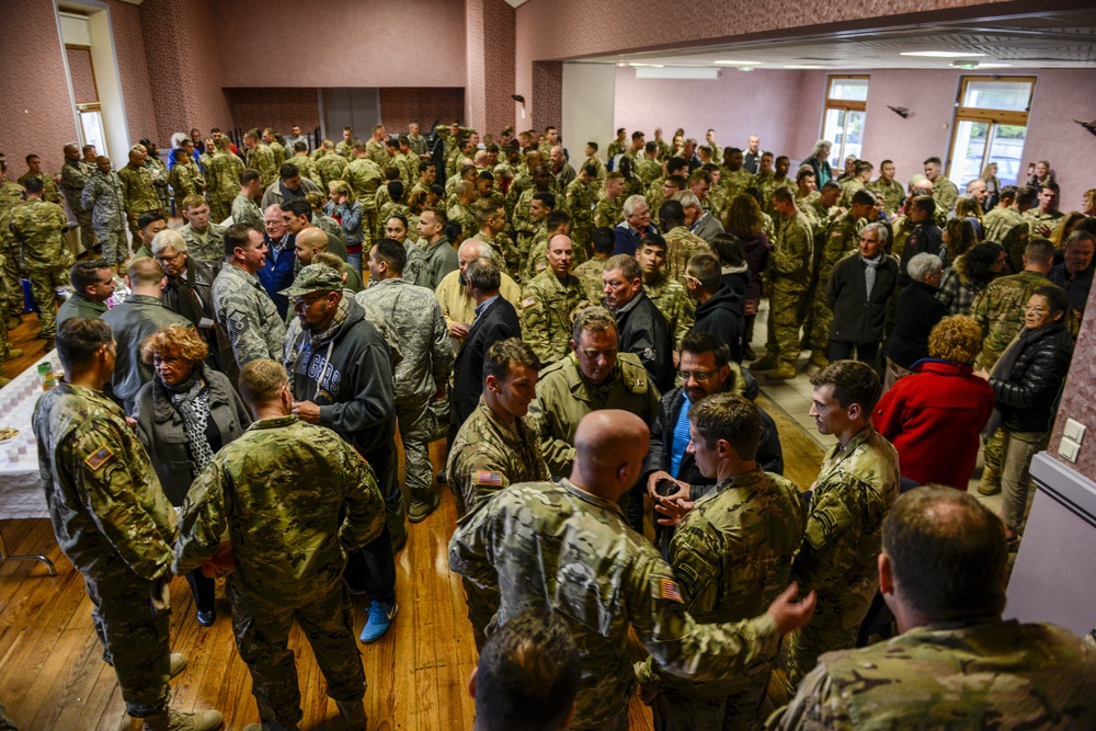 US service members dine with French families