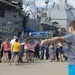 Friends and families of Sailors aboard USS San Jacinto (CG 56) watch from the pier as the ship prepares to deploy. departs Naval Station Norfolk with the USS Dwight D. Eisenhower Carrier Strike Group (CSG).