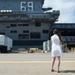 Sarah Osorio, spouse of a Sailor assigned to the aircraft carrier USS Dwight D. Eisenhower (CVN 69), watches as the ship prepares for departure.