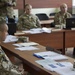 Ukrainian Soldiers receive a class from a fellow classmate