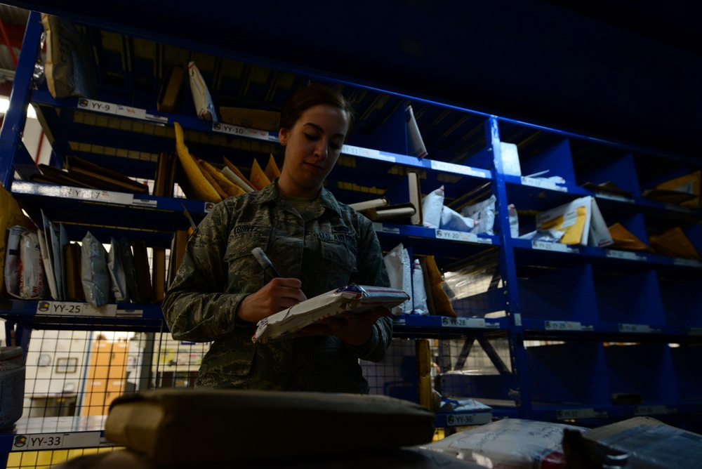 Postal workers prepare parcels for pickup