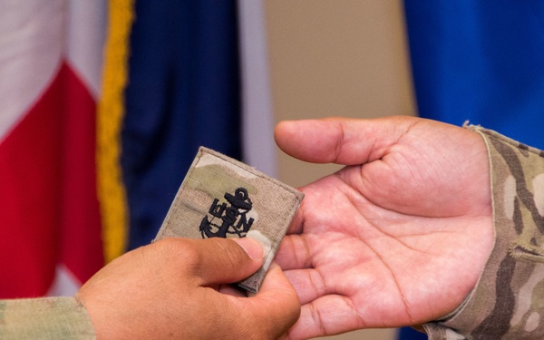 Newly frocked Senior Chief Iris Gonzales changes her rank insignia