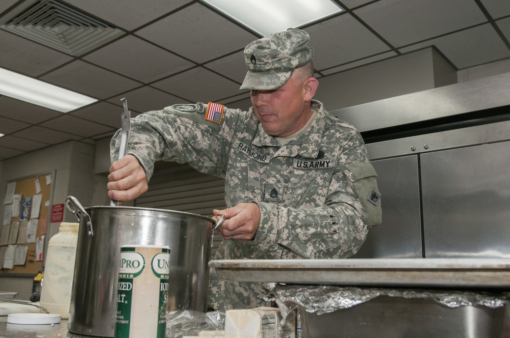 Soldier Stirs Pot of Macaroni