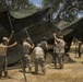 Soldiers set up camo nets
