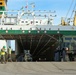 Marines move gear from ship to convoy