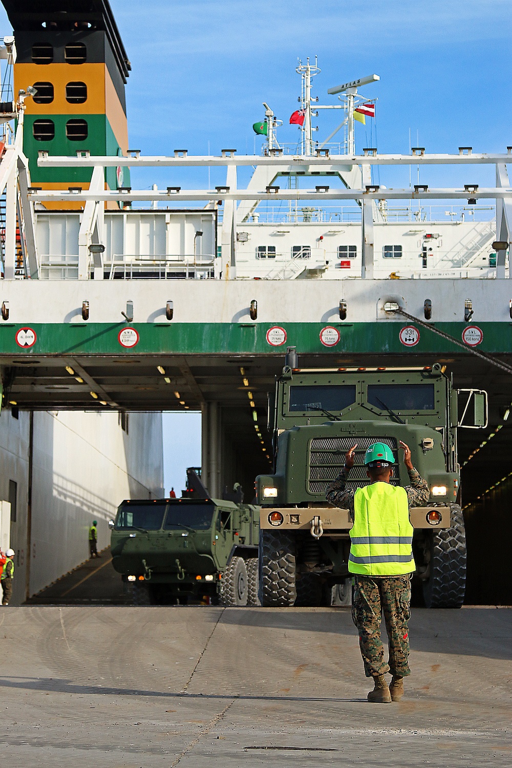 Marines move gear from ship to convoy