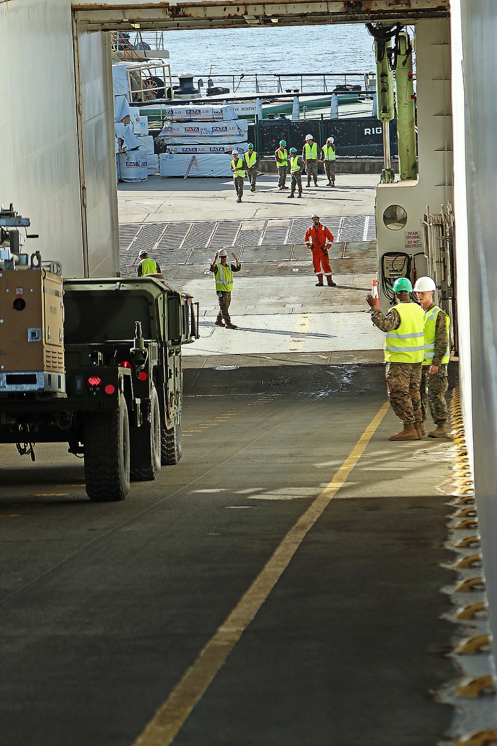 Marines move gear from ship to convoy