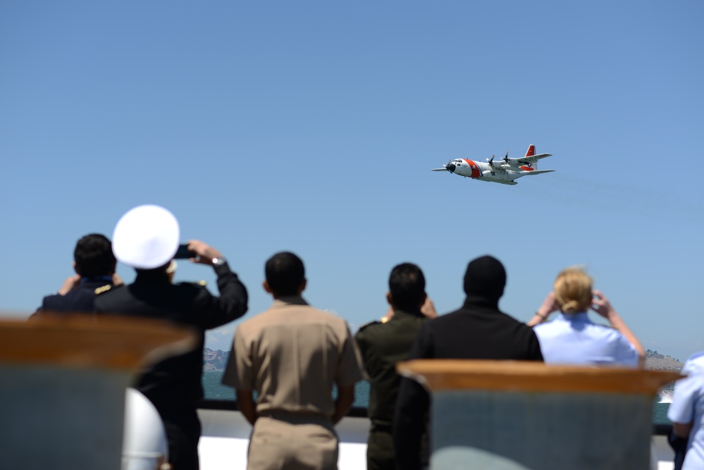 An Air Station Sacramento C-130 airplane flies by the USCGC Aspen