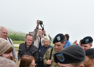 1ID veteran meets and signs patches of 1ID Soldiers at Omaha Beach memorial ceremony