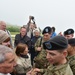 1ID veteran meets and signs patches of 1ID Soldiers at Omaha Beach memorial ceremony