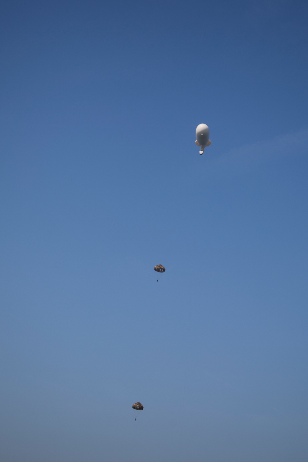 U.S. Army paratroopers jump from a balloon in Belgium