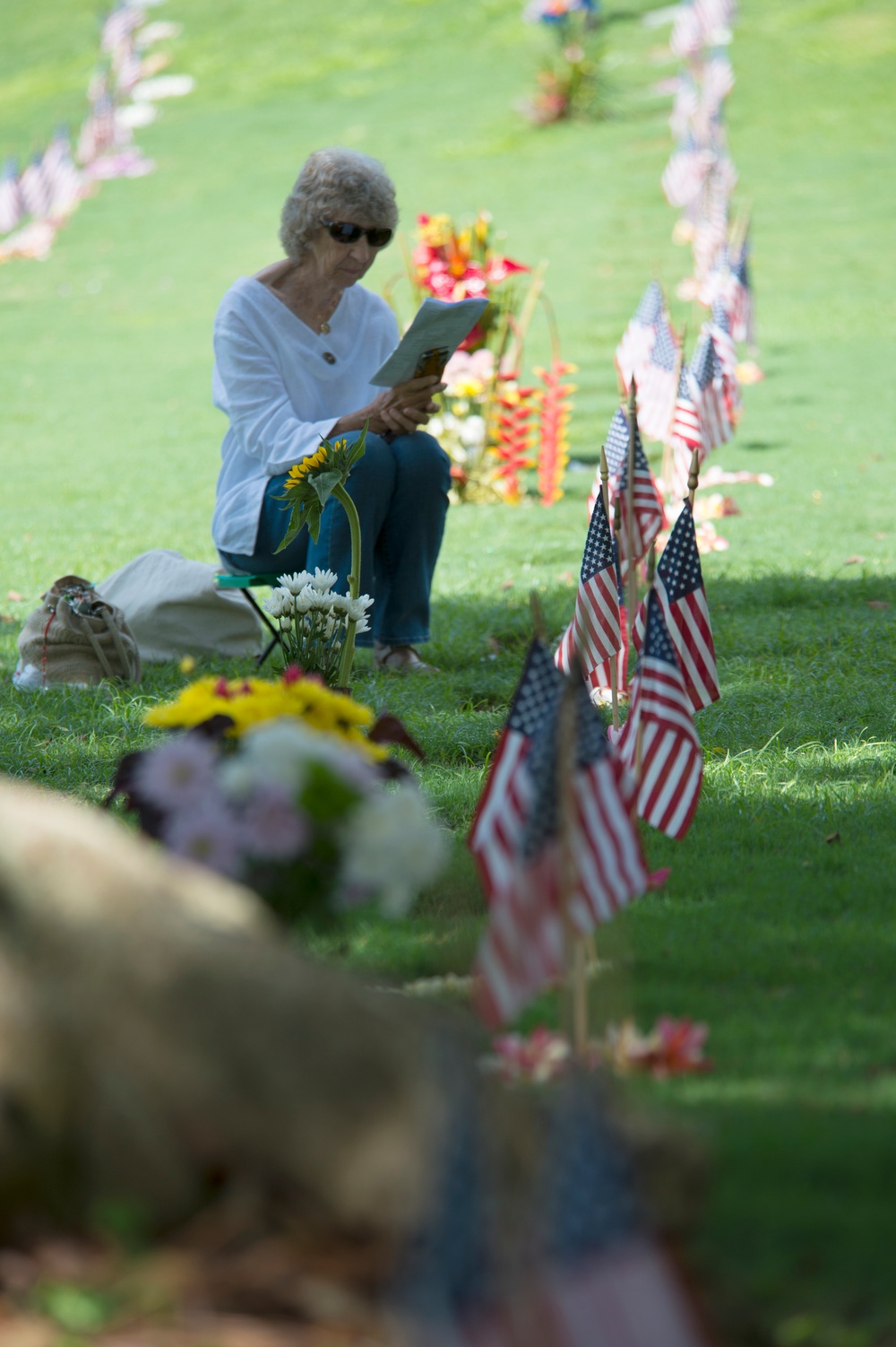 Widow Sits Near Husband's Grave