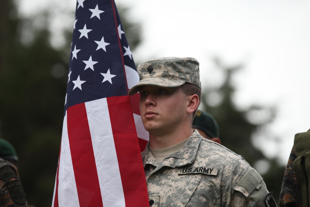 Spc. Mathew Thompson proudly carries American flag with Guatemalan color guard.