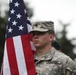 Spc. Mathew Thompson proudly carries American flag with Guatemalan color guard.