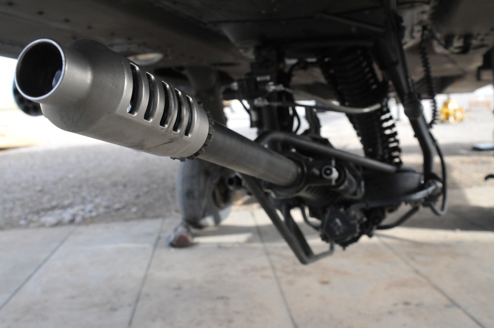 An AH-64 Apache helicopter’s 30mm M230 chain gun sits loaded and on standby..